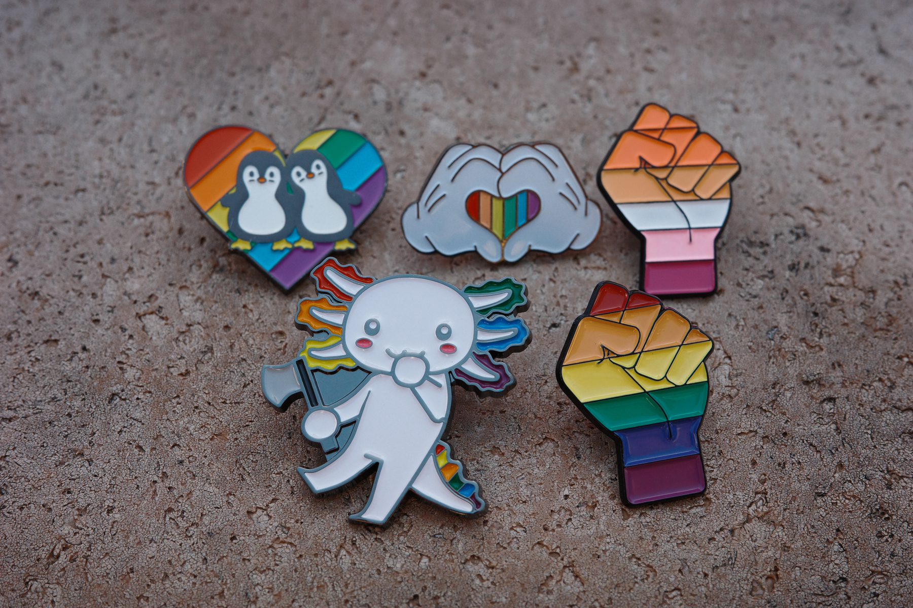 Five Pride related enamel pins